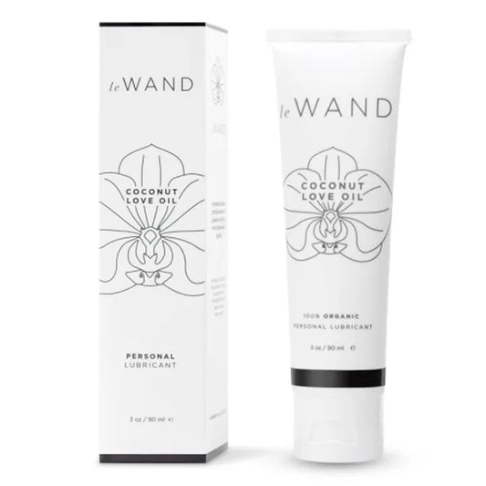 Le Wand Coconut Oil Lubricant packaging and tube. The product is displayed with its box, which has the same design as the tube, featuring a white color with black and green text and graphics.