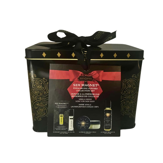 A black gift set box with a bow, containing a roll-on fragrance, massage oil, and massage candle, labelled 'Sex Magnet' with a red and gold color scheme.