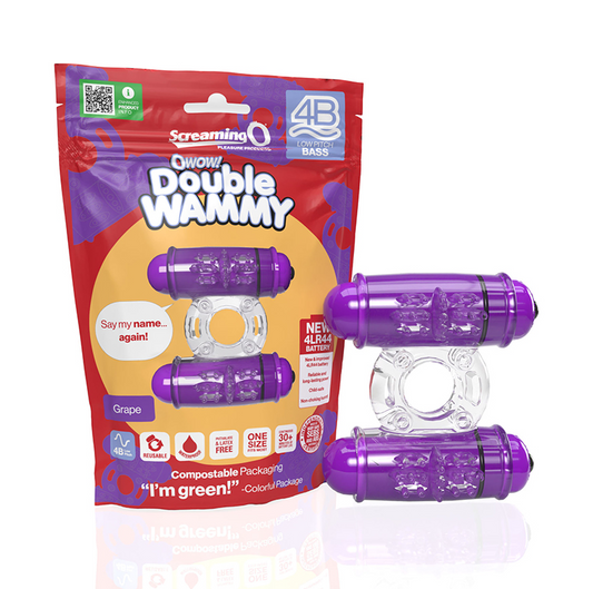 The image shows the Screaming O 4B Double Wammy in grape color, with a clear SEBS material and dual 4B motors. The product is displayed both in and out of its packaging, which features a vibrant grape color scheme and playful branding.