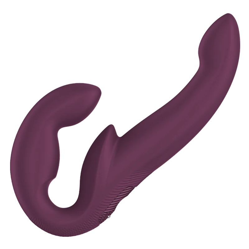 Harness-compatible strapless vibrator with adjustable hinge