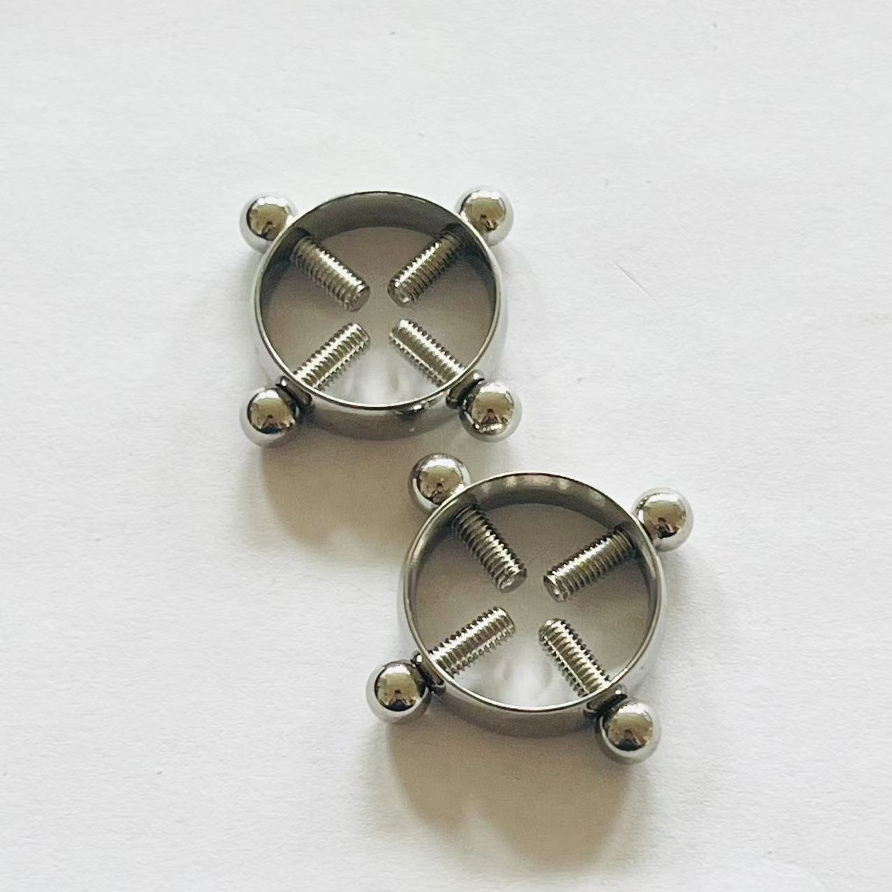 Pair of stainless steel 4-screw nipple press rings