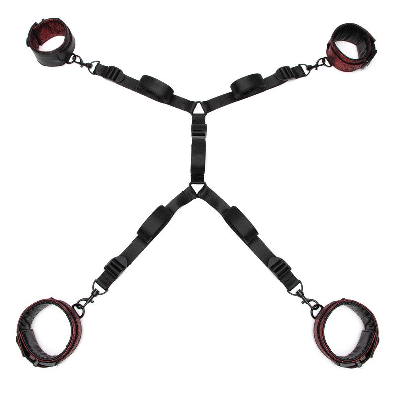 Black restraint set with red leather cuffs on a white background