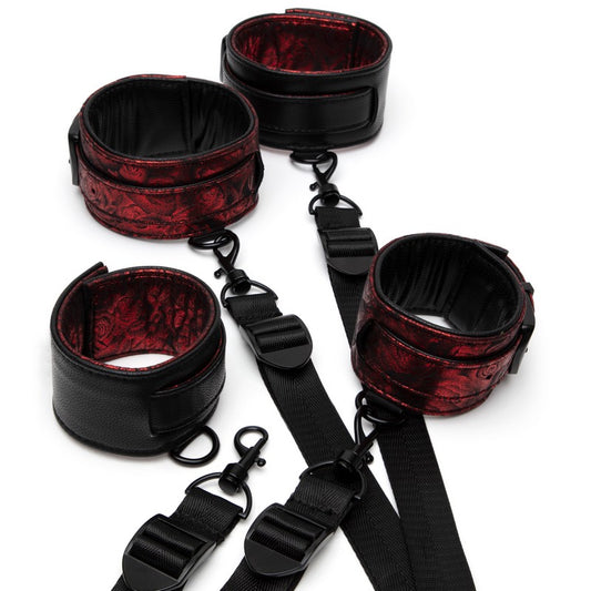 Black and red leather restraint set on a white background