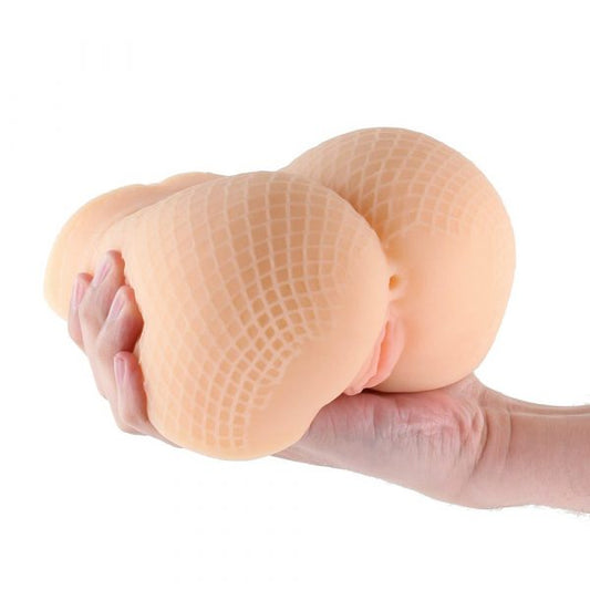 Hand holding a silicone breast form against a white background
