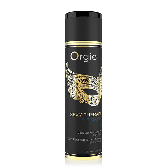 A tube of Orgie Sexy Therapy massage oil with a black background and gold accents on the label.