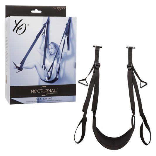 The image shows the CalExotics Nocturnal Collection Sex Swing, with both the swing itself and its packaging visible. The swing appears black with adjustable straps and a padded seat, and is designed to be attached over doors.