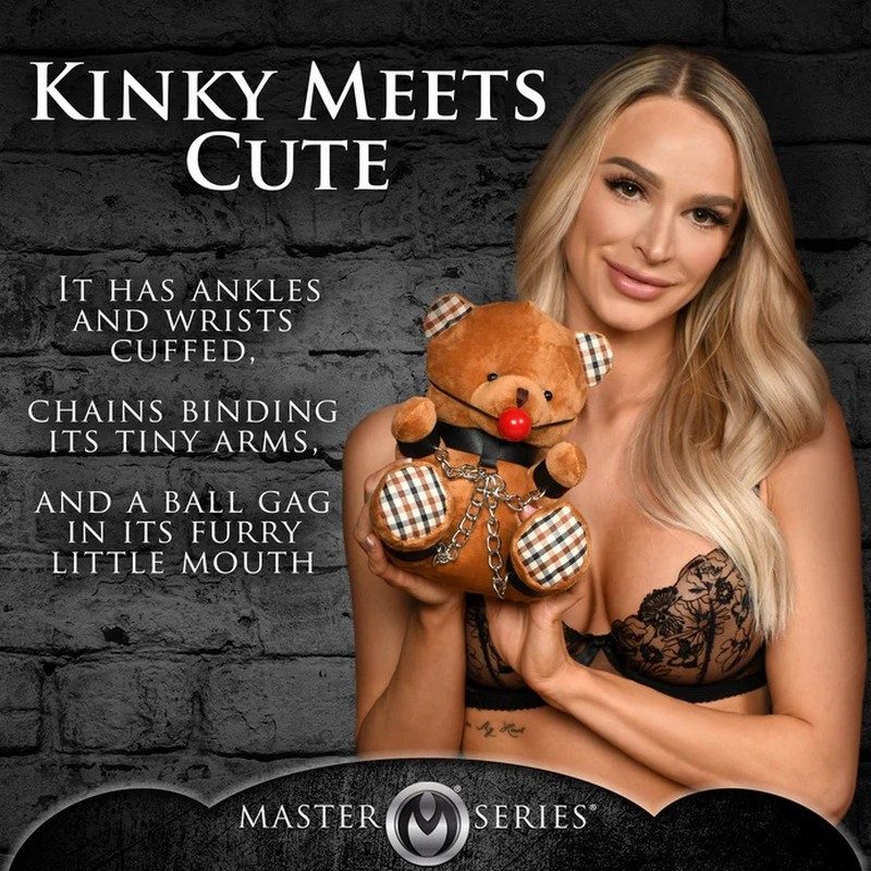 Woman holding a teddy bear with chains and text on a dark brick wall background