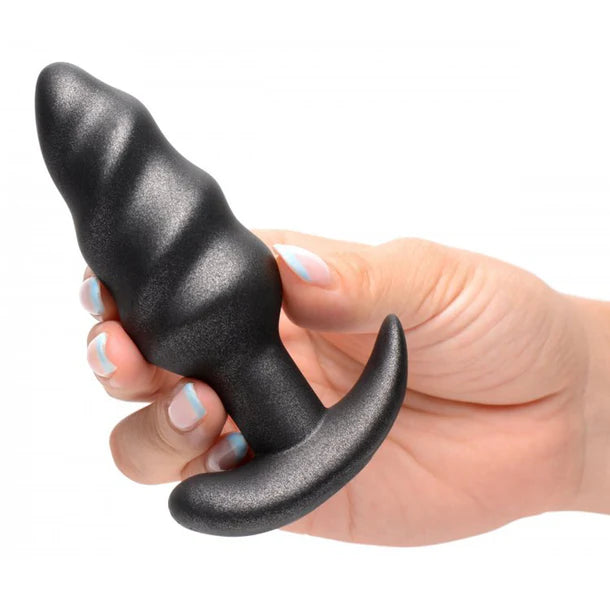 Metallic black swirl vibrating butt plug with remote control, curved base design, displayed in packaging – 25X Platinum Series