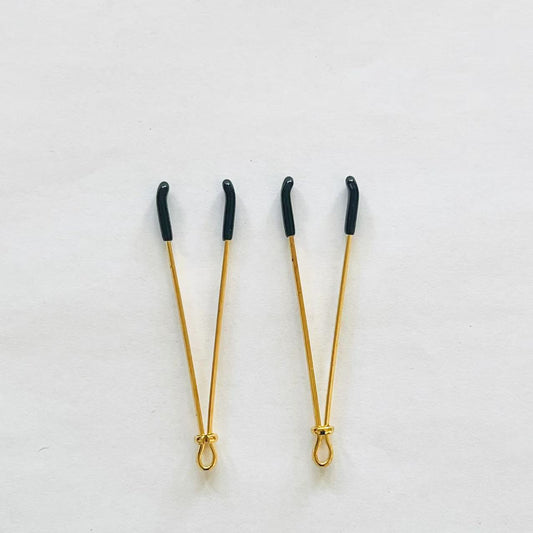 Gold adjustable wire-style nipple clamps with black rubber tips, minimalist BDSM design