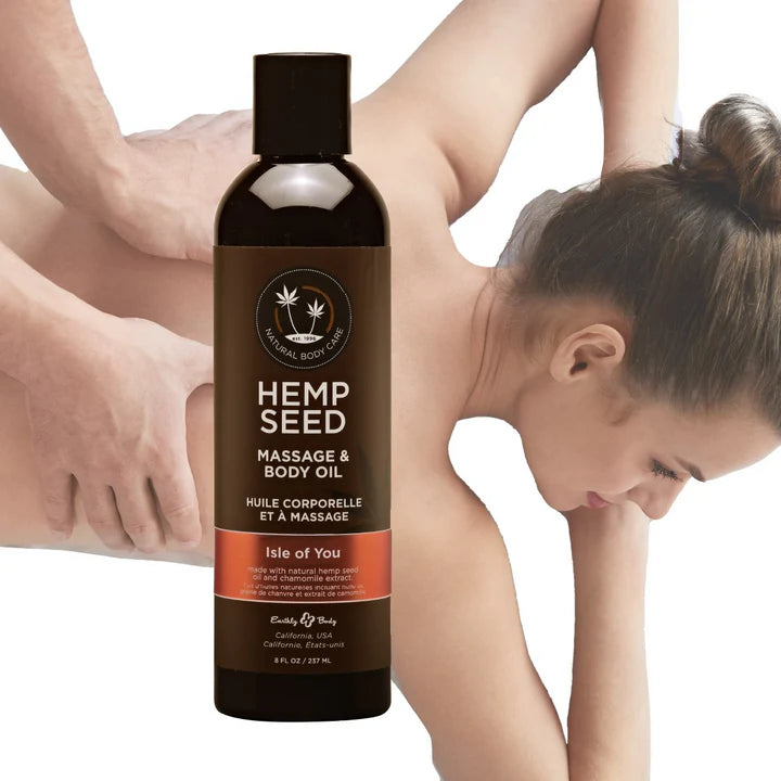 Bottle of Hemp Seed Massage & Body Oil with a woman massaging her arm in the background