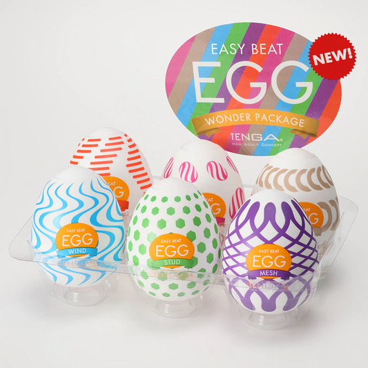 A set of six Tenga Egg masturbators in various designs, each with a colorful, patterned exterior. The packaging highlights the variety pack feature and includes a label for 'new!'.