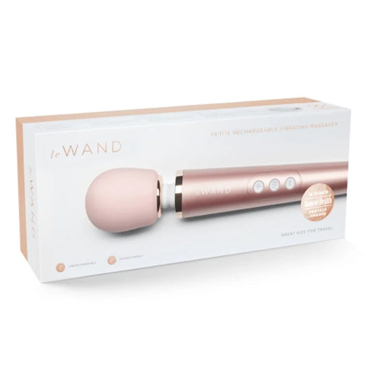 Rose gold handheld massager with packaging on a white background