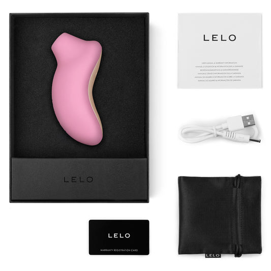 LELO pink electronic device with packaging, USB cable, and warranty card on a white background