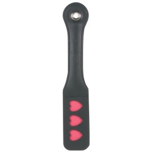 A black leather paddle with red heart-shaped embellishments on the handle.