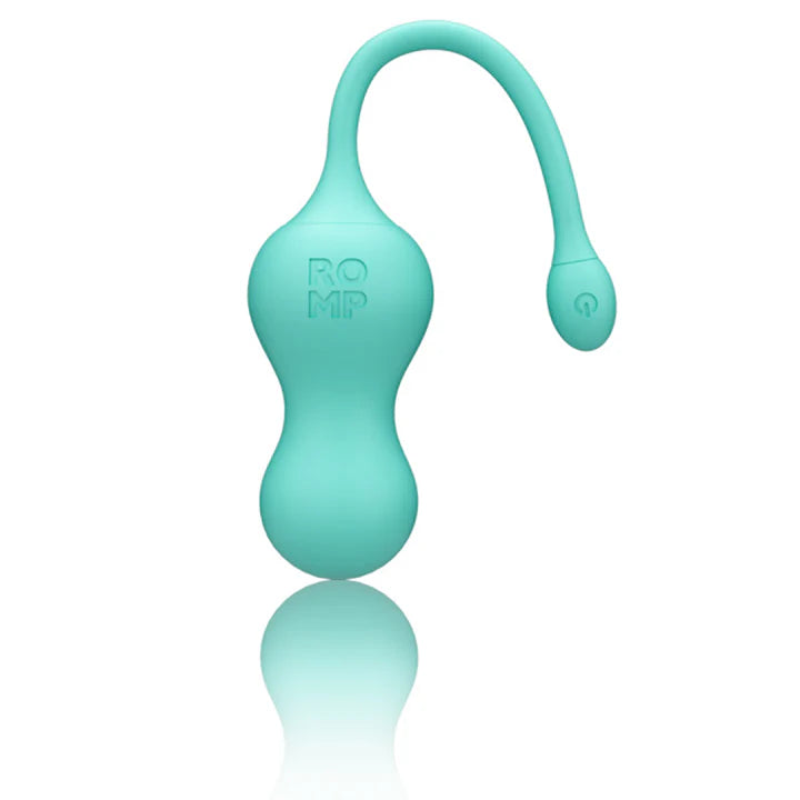ROMP Cello vibrator next to USB cable and remote