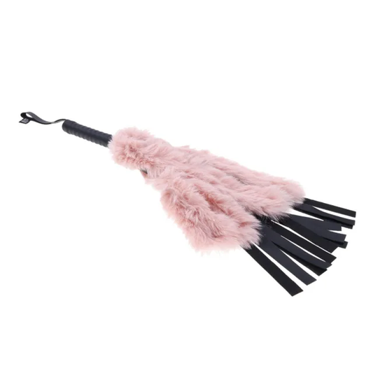 A faux fur flogger with a rose gold handle and black faux fur falls, designed for BDSM play.