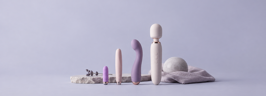 Different vibrator sizes arranged together in a clean minimal product photography setting