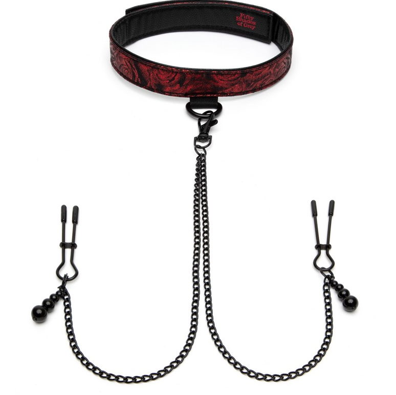 The image shows a black and red padded collar connected to adjustable nipple clamps by a chain. The collar has a satin-like texture on one side and a faux leather finish on the other, with a padded rose-print design.
