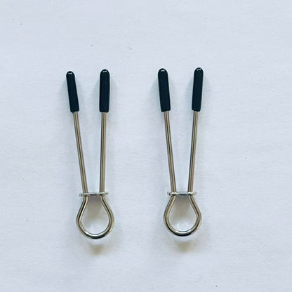 Minimalist stainless steel loop nipple clamps with black rubber tips on white background.