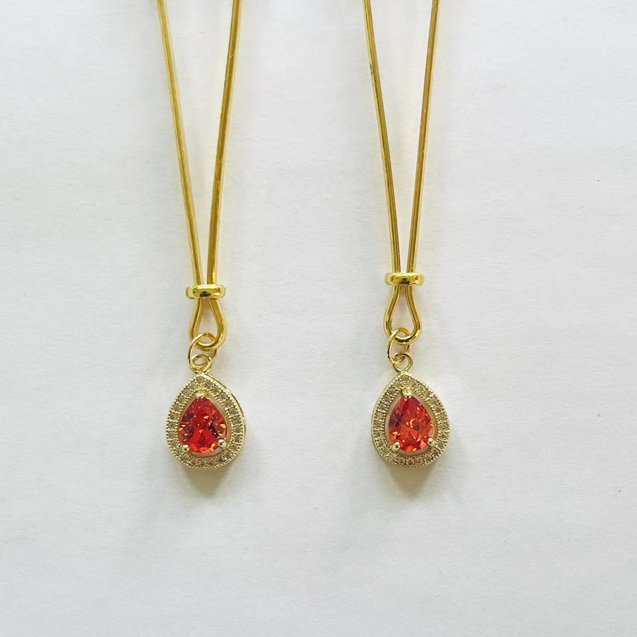 Gold nipple clamps with red-orange teardrop gem and crystal halo – PurpleNight.ca