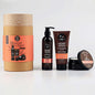 A gift set containing shower spa products, including a shampoo, conditioner, body lotion, and a bath and shower gel, packaged in a brown paper bag with branding and product labels.