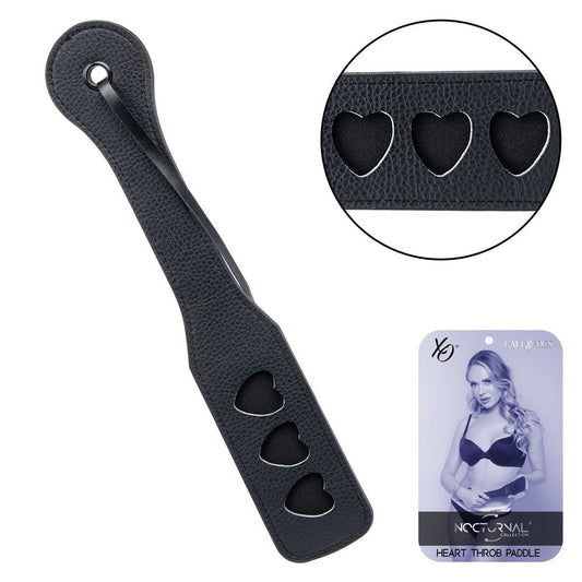 Black paddle with heart-shaped holes and Nocturnal brand packaging on a white background