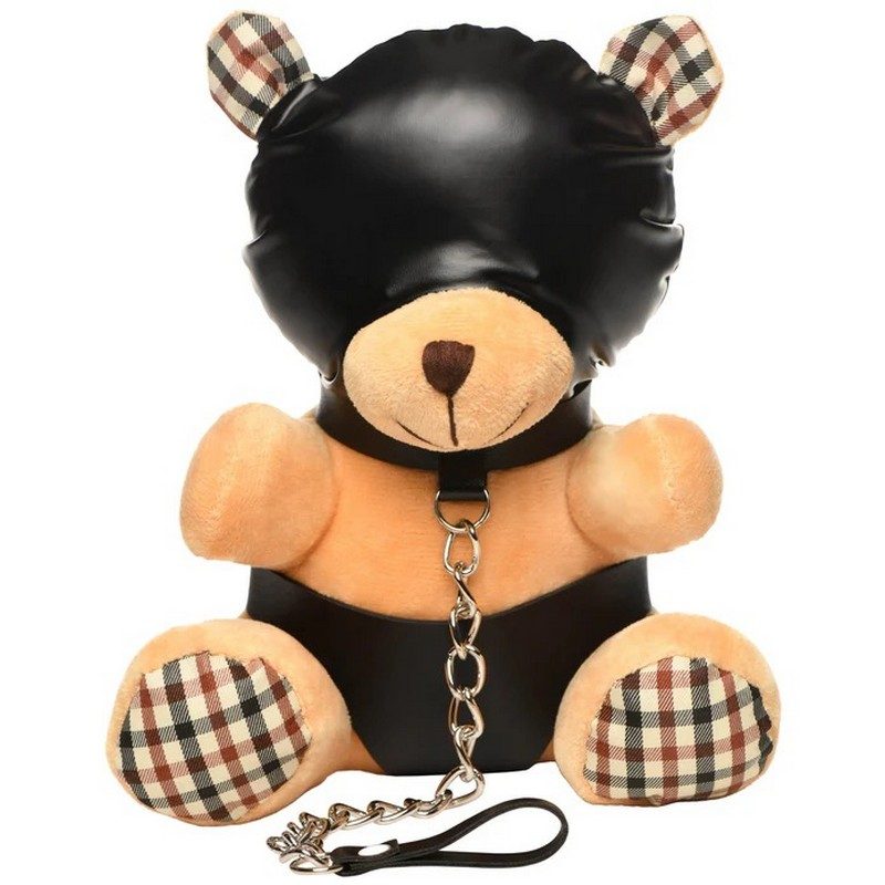 Teddy bear with leather harness and checkered details on a white background