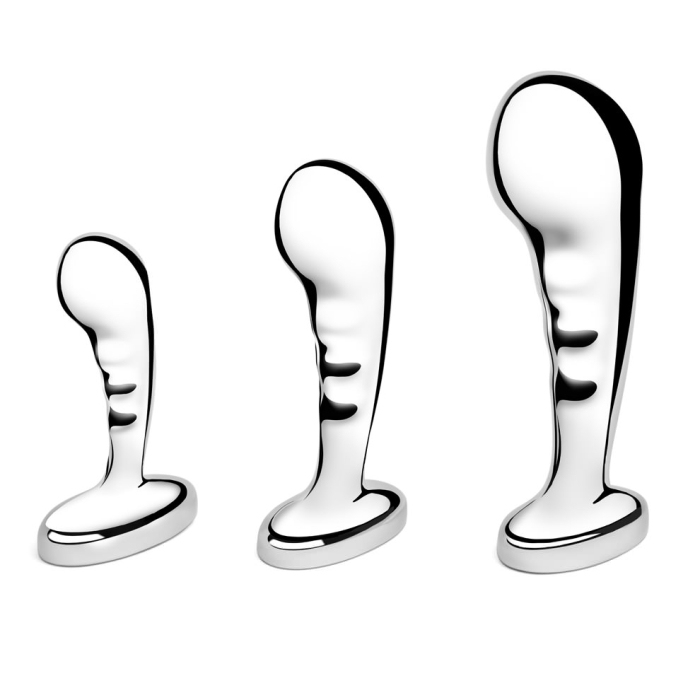 Three stainless steel anal plugs from the b-Vibe P-Spot Training Set in small, medium, and large sizes displayed against a reflective background.