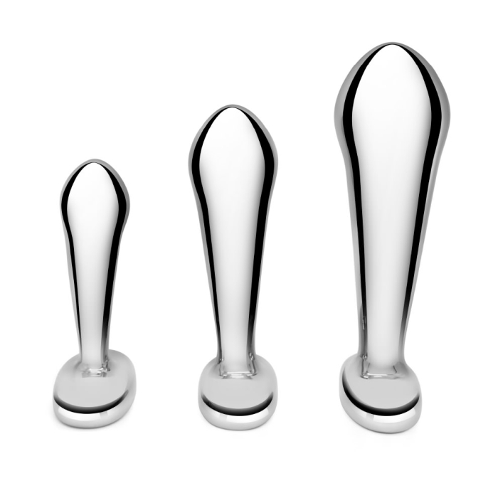 Three stainless steel anal plugs from the b-Vibe P-Spot Training Set in small, medium, and large sizes displayed against a reflective background.