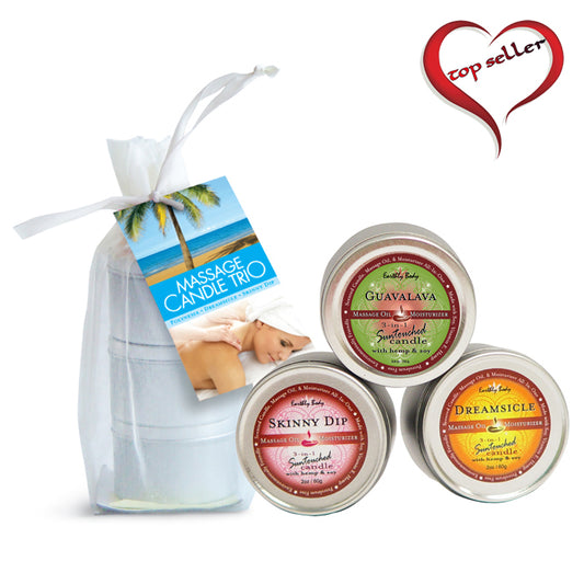 Three massage candles in different scents, displayed in a clear bag with a white label that reads 'MASSAGE TRIO'. The candles are in a line with the first candle labeled 'GUAVALAYA', the second candle labeled 'DREAMSCAPE', and the third candle labeled 'SKINNY DIP'.